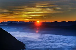 Landscapes Prints: Fog covers the Inntal valley as the sunrise is seen from the Hundskopf mountain in
