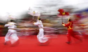 Folk dancers holding horse models perform their traditional horse dance on the first Folk dancers holding horse models perform their traditional horse dance on the first