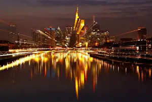 Prints of The Frankfurt skyline with its financial district is photographed on early evening in Frankfurt, Germany, March 25, 2018. Picture is taken with long time exposure while using the zoom Global Prints: The Frankfurt skyline with its financial district is photographed on early evening in