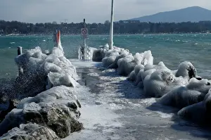 Weather Prints: A frozen pier is seen during a windy winter day near Lake Leman in Geneva