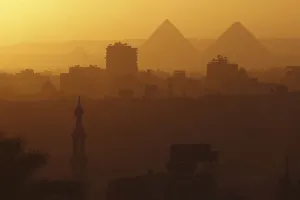Egypt Prints: A general view of mosques and the great pyramids before sunset in Cairo