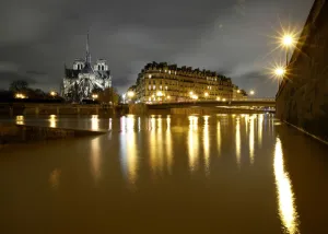 France Prints: A general view shows the Notre Dame Cathedral at night, on the flooded banks of the River