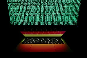 Cyber Prints: German flag is seen on the laptop screen in front of a computer screen on which cyber