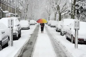 Prints of A girl walks along a snow covered street in Knaresborough, northern England January 21, 2013 Britain Prints: A girl walks along a snow covered street in Knaresborough