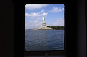 <b class=qtipBold><figcaption>GM1E47104W001</figcaption></b><br>The Statue of Liberty is through a cabin window in this photograph taken from a tour boat in New York Harbor, June 30, 2008. REUTERS/Mike Segar (UNITED STATES) GM1E47104W001