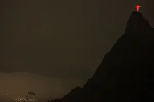 Prints of The statue of Christ the Redeemer is seen lit up in red atop the Corcovado mountain during a World AIDS Day event in Rio de Janeiro December 1, 2009 Brazil Prints: GM1E5C20NE401