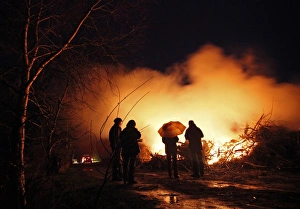 <b class=qtipBold><figcaption>GM1E6440FDV01</figcaption></b><br>People brave the rain as they stand around a traditional Easter fire in the small village of Worpswede, near Bremen, April 3, 2010. REUTERS/Christian Charisius (GERMANY - Tags: SOCIETY RELIGION) GM1E6440FDV01