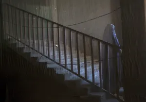 <b class=qtipBold><figcaption>GM1E6CD1CRP01</figcaption></b><br>A photograph taken from behind a curtain shows an Afghan Shi'ite Muslim woman clad in burqa stand at the entrance of Chendawol mosque during a Muharram procession to mark Ashura in Kabul December 13, 2010. Ashura, which falls on the 10th day of the Islamic month of Muharram, commemorates the death of Imam Hussein, grandson of Prophet Mohammad, who was killed in the 7th century battle of Kerbala. REUTERS/Ahmad Masood (AFGHANISTAN - Tags: RELIGION SOCIETY) GM1E6CD1CRP01