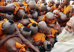 <b class=qtipBold><figcaption>GM1E7261TXT01</figcaption></b><br>Boys get blessings from Swami Nitya Gopal Ji Mahar (R), a Hindu holyman, after wearing a "janeyu" or sacred thread during a ritual in the northern Indian city of Allahabad February 6, 2011. The janeyu, which is a thin, consecrated cord composed of distinct cotton strands, is worn to symbolize the coming of age among adolescent Brahmin, or high caste Hindu, males. REUTERS/Jitendra Prakash (INDIA - Tags: RELIGION SOCIETY IMAGES OF THE DAY) GM1E7261TXT01
