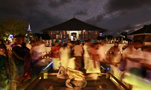 <b class=qtipBold><figcaption>GM1E75I03L001</figcaption></b><br>Buddhist devotees arrive at a temple to attend a religious ceremony on Vesak day in Colombo May 17, 2011. Vesak Day commemorates the birth, enlightenment and death of Gautama Buddha. REUTERS/Dinuka Liyanawatte (SRI LANKA - Tags: RELIGION SOCIETY) GM1E75I03L001