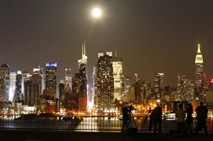 <b class=qtipBold><figcaption>GM1E94Q0SP001</figcaption></b><br>People photograph the full moon as it rises over the skyline of New York City near 42nd Street (C), as seen across the Hudson River in Weehawken, New Jersey April 25, 2013. REUTERS/Gary Hershorn (UNITED STATES - Tags: CITYSCAPE ENVIRONMENT TPX IMAGES OF THE DAY) - RTXZ0FA GM1E94Q0SP001