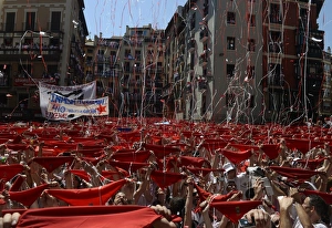 <b class=qtipBold><figcaption>GM1E9761PGU01</figcaption></b><br>Revellers hold up their red scarves during the start of the San Fermin festival in Pamplona July 6, 2013. The beginning of the festival, known as the Chupinazo, was postponed for 20 minutes while authorities removed a Basque flag hanging in front of the town hall. The annual San Fermin festival, famous for the running of the bulls event, started on Saturday and runs until July 14. REUTERS/Vincent West (SPAIN - Tags: SOCIETY) - RTX11EKA GM1E9761PGU01