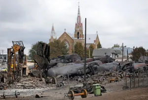 <b class=qtipBold><figcaption>GM1E9791T3N01</figcaption></b><br>Wagons of the train wreck are seen in Lac Megantic, July 9, 2013. The crude oil freight train that derailed and blew up in the small town of Lac-Megantic early on Saturday morning was traveling far too fast when it went off the rails, investigators told reporters on Tuesday. REUTERS/Mathieu Belanger (CANADA - Tags: TRANSPORT DISASTER) - RTX11HQI GM1E9791T3N01