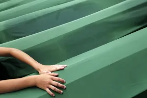 <b class=qtipBold><figcaption>GM1E97B1C9A01</figcaption></b><br>A Bosnian child cries as he touches the coffin of a relative, which is one of 409 coffins of newly identified victims of the 1995 Srebrenica massacre, in Potocari Memorial Center, near Srebrenica July 11, 2013. The bodies of the recently identified victims will be transported to the memorial centre in Potocari where they will be buried on July 11 marking the 18th anniversary of the massacre in which Bosnian Serb forces commanded by Ratko Mladic killed up to 8, 000 Muslim men and boys and buried them in mass graves. REUTERS/Dado Ruvic (BOSNIA AND HERZEGOVINA - Tags: SOCIETY CIVIL UNREST) - RTX11JMB GM1E97B1C9A01
