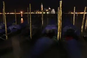 Italy Prints: Gondolas are seen along the Canal Grande in front of San Giorgio Maggiore church in