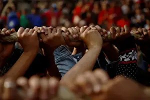 Nepal Prints: Hands of devotees are pictured as they pull the chariot of God Bhairab during the Biska