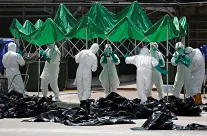 Health officers set up a marquee as they cull poultry at a wholesale market in Hong Kong