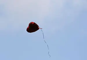 A heart-shaped balloon floats upward during the Seventh Anniversary September 11 Commemoration