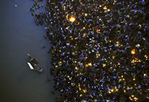Hindu devotees gather to worship the Sun god Surya on the banks of the Ganges river