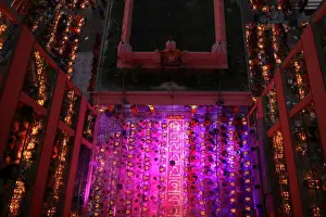 Bangladesh Prints: Hindu devotees sit together on the floor of a temple to observe Rakher Upabash, in Dhaka