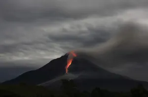 Indonesia Prints: Hot lava spews from Mount Sinabung as seen from Jraya village in Karo district