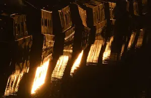 Houseboats glisten in late afternoon sunshine along their moorings on the Regent s