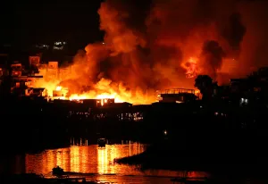 Prints of Houses on fire are seen at Educandos neighbourhood, a branch of the Rio Negro, a tributary to the Amazon river, in the city of Manaus, Brazil December 17, 2018. Picture taken December 17, 2018 Brazil Prints: Houses on fire are seen at Educandos neighbourhood, a branch of the Rio Negro
