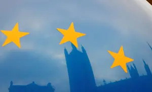 The Houses of Parliament are reflected in an EU flag balloon in London
