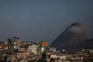 Houses at the Santo Amaro slum are seen with the Sugar Loaf mountain in the background