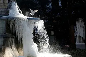 Ice partially covers a fountain on a cold winter day in central Brussels