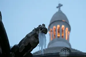 : Icicles hang from a gargoyle on the Sacre Coeur basilica at the Butte Montmartre in Paris