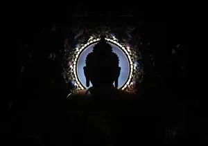 An idol of Buddha is silhouetted at the Tibetan Monastery in Lumbini An idol of Buddha is silhouetted at the Tibetan Monastery in Lumbini