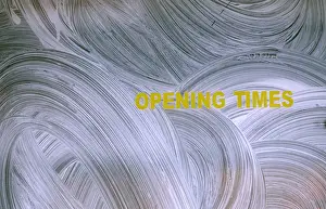 An incomplete opening times sign is displayed on the window of a closed shop in Shoreditch