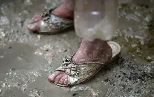 Mideast Prints: An internally displaced Syrian girl stands in the mud after heavy rain at a camp on