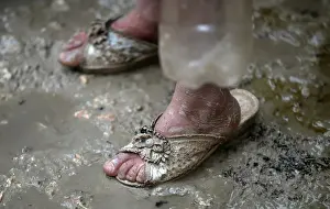 Mideast Prints: An internally displaced Syrian girl stands in the mud after heavy rain at a camp on