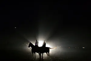 Israeli policemen sit on their horses in a standby position on the field outside the Israeli policemen sit on their horses in a standby position on the field outside the