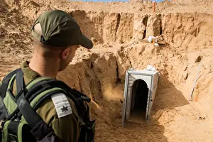 Palestinian Prints: An Israeli soldier stands next to an entrance to what the Israeli military say is a