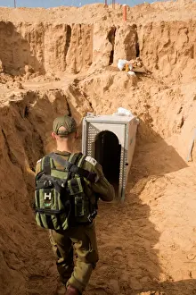Palestinian Prints: An Israeli soldier stands next to an entrance to what the Israeli military say is a