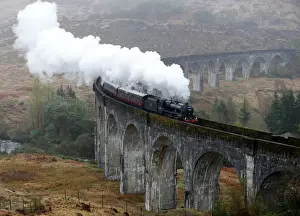 The Jacobite steam train crosses the Glenfinnan Viaduct in Scotland
