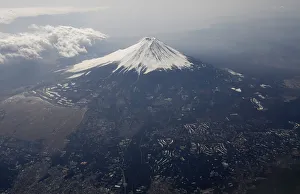 Japan Prints: Japans Mount Fuji is seen covered with snow from an airplane