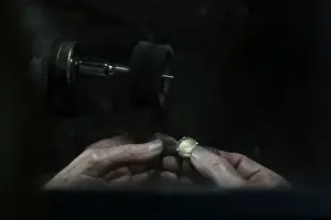 A jeweller smoothens a gold medal at his workshop in central Madrid