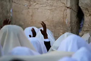 Jewish worshippers wrapped in prayer shawls participate in the priestly blessing prayer