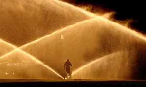 A jogger makes his way past sprinklers in Washington