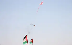 Prints of A kite loaded with a flammable material is flown by Palestinian demonstrators to be thrown at the Israeli side during a protest marking al-Quds Day, (Jerusalem Day), at the Israel-Gaza border Israel Prints: Kite loaded with a flammable material is flown by Palestinian demonstrators to be thrown