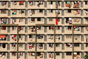 Laundry is seen hanging on the windows of a residential building in Mumbai