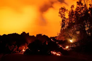 Hawaii Prints: A lava flow from the Kilauea volcano illuminates the night sky