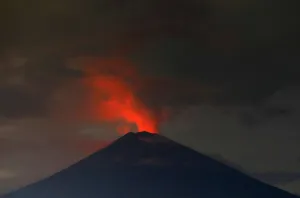 Indonesia Prints: Lava, inside the crater of Mount Agung volcano, reflects off ash