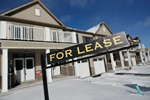 Images Dated 2018 February: A For lease sign stands in front of a row of houses in a newly build subdivision in