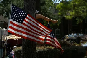 The leg of a mannequin is nailed to a tree outside a flooded damaged home following the The leg of a mannequin is nailed to a tree outside a flooded damaged home following the