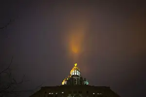 Light pours into fog bank from Manhattan Municipal building in Manhattan borough of